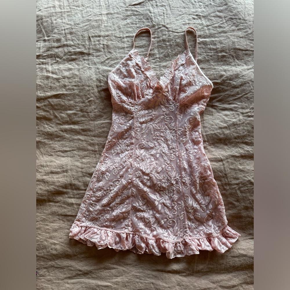 SOLD Baby Pink lace ruffled slip with a floral pattern and ruffle hem.